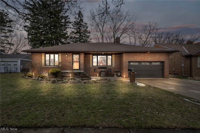 view of front of property featuring a yard and a garage