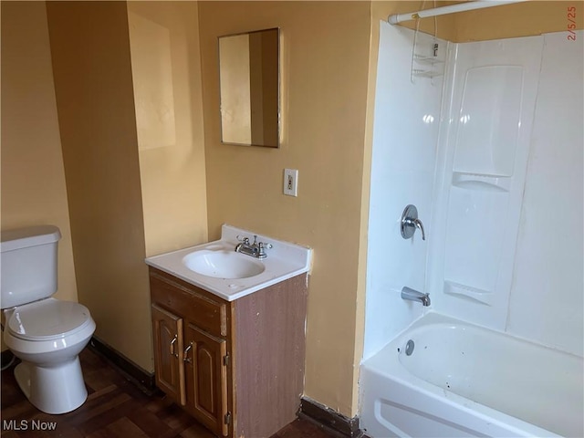 full bathroom featuring washtub / shower combination, vanity, and toilet