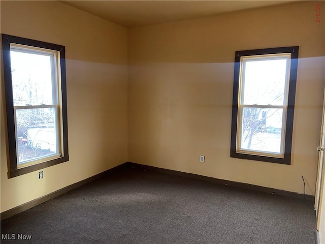 carpeted empty room with plenty of natural light