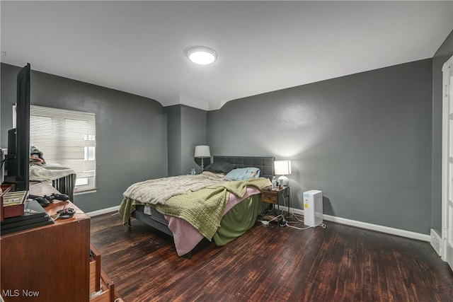 bedroom featuring dark wood-type flooring