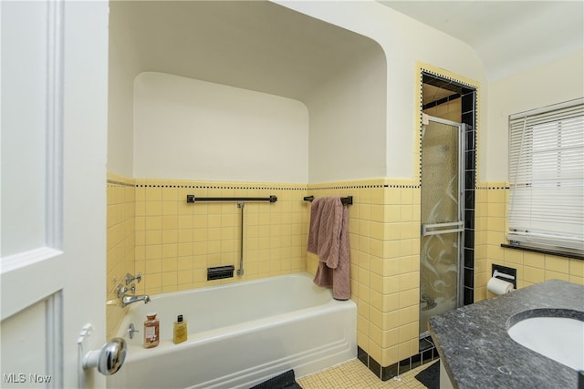 bathroom featuring tile walls, sink, tile patterned flooring, and a bathing tub