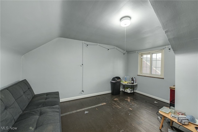 additional living space with dark hardwood / wood-style flooring and vaulted ceiling