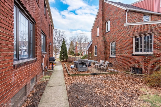 view of side of property with a patio area