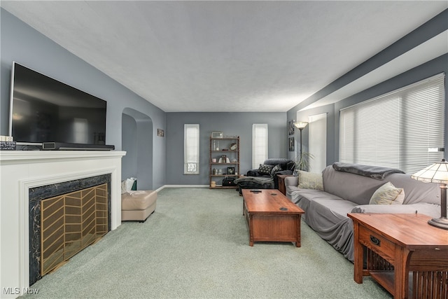 carpeted living room with a fireplace