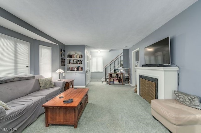 living room featuring light carpet and plenty of natural light