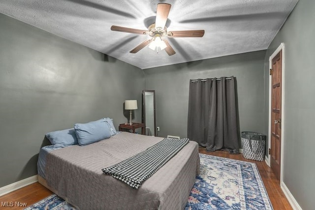 bedroom with hardwood / wood-style flooring and ceiling fan