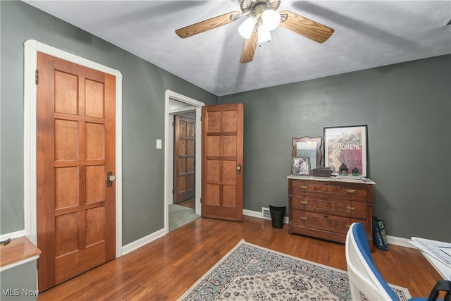 office space featuring wood-type flooring and ceiling fan