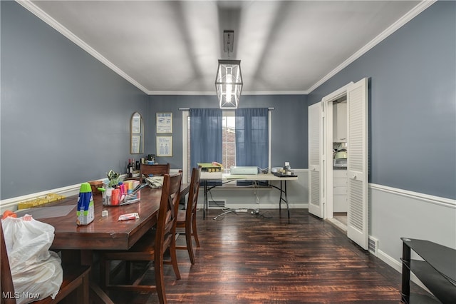 dining room featuring ornamental molding and dark hardwood / wood-style floors