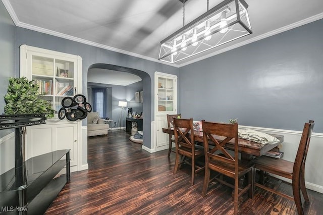 dining space with ornamental molding, dark hardwood / wood-style floors, and a chandelier