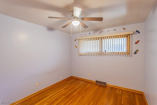 unfurnished room featuring hardwood / wood-style floors and ceiling fan