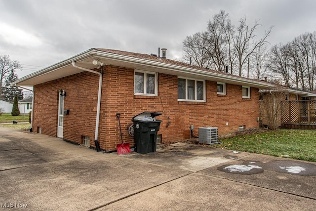 rear view of property featuring a patio area and central air condition unit