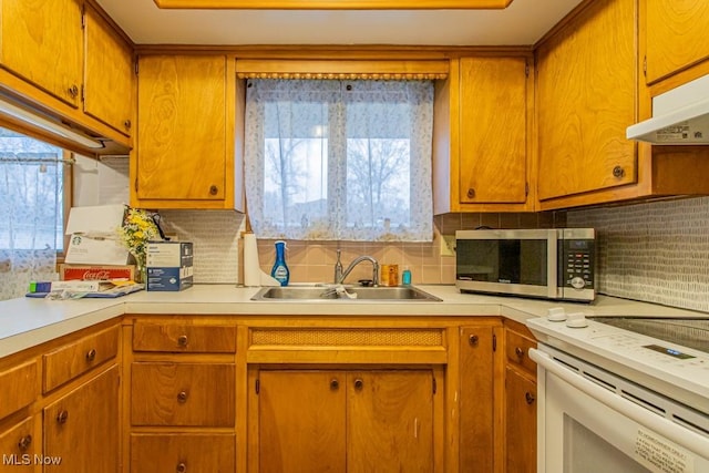 kitchen with sink, white electric range, and backsplash