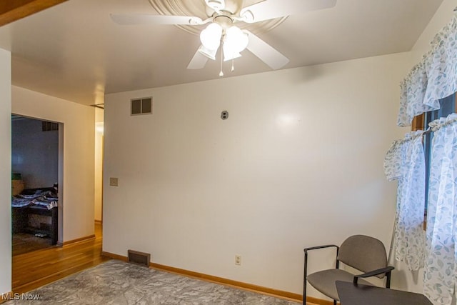 interior space with ceiling fan