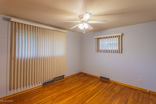 spare room featuring hardwood / wood-style flooring and ceiling fan