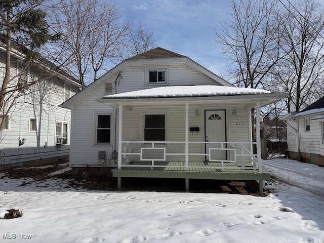 bungalow-style home featuring cooling unit and a porch