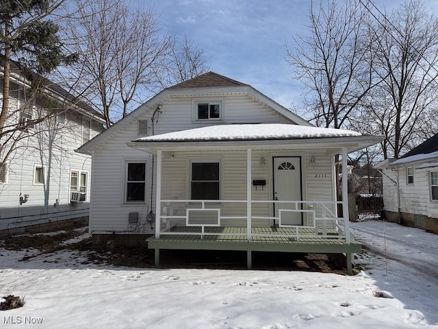 bungalow with cooling unit and covered porch