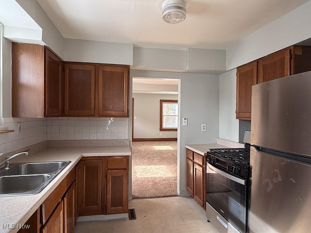 kitchen featuring sink, backsplash, and stainless steel appliances