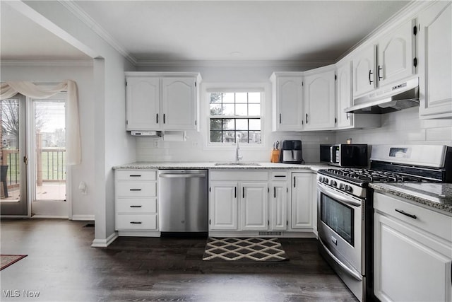 kitchen featuring sink, appliances with stainless steel finishes, light stone counters, ornamental molding, and white cabinets