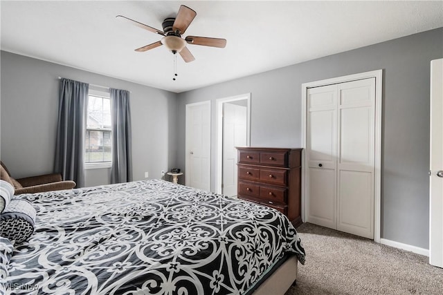 carpeted bedroom featuring ceiling fan and a closet