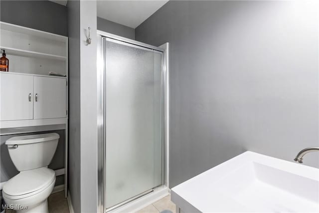 bathroom with sink, an enclosed shower, tile patterned floors, and toilet