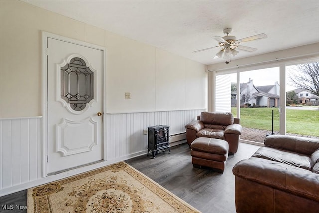 interior space with a baseboard heating unit and ceiling fan