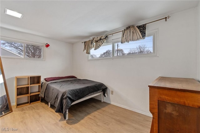 bedroom featuring light wood-style flooring and baseboards