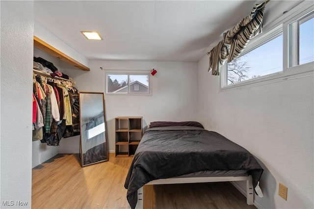 bedroom with light wood-style flooring and a closet