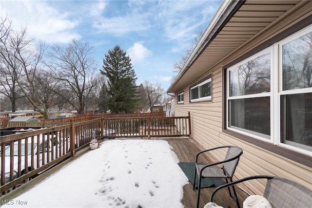 snow covered deck with fence