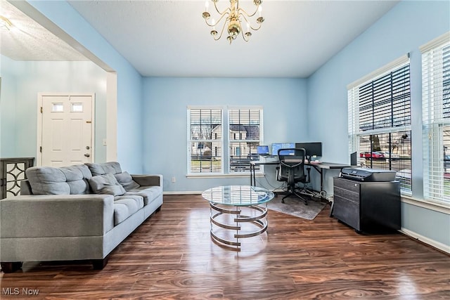 office area with dark hardwood / wood-style flooring, a wealth of natural light, and a chandelier