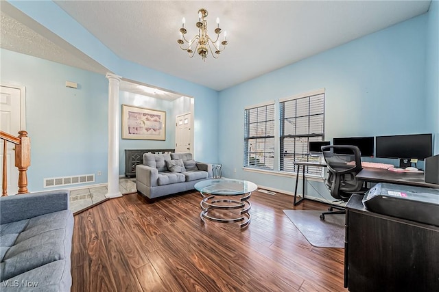 office area featuring an inviting chandelier, hardwood / wood-style floors, and ornate columns