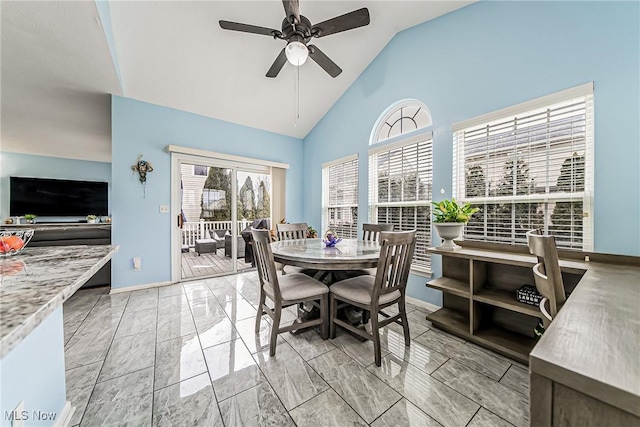 dining area featuring ceiling fan and high vaulted ceiling