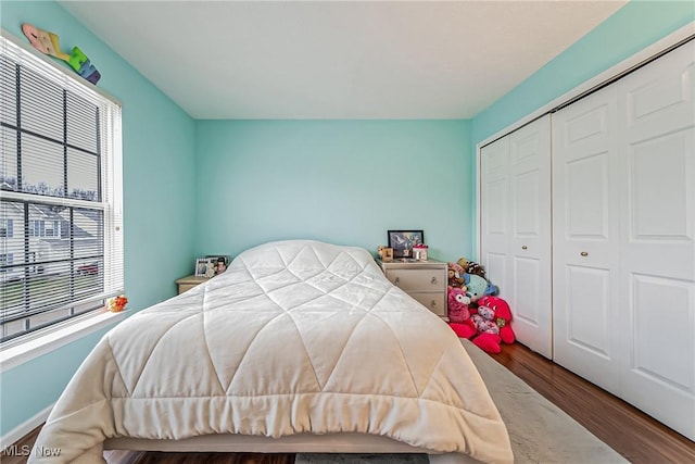 bedroom with wood-type flooring and a closet