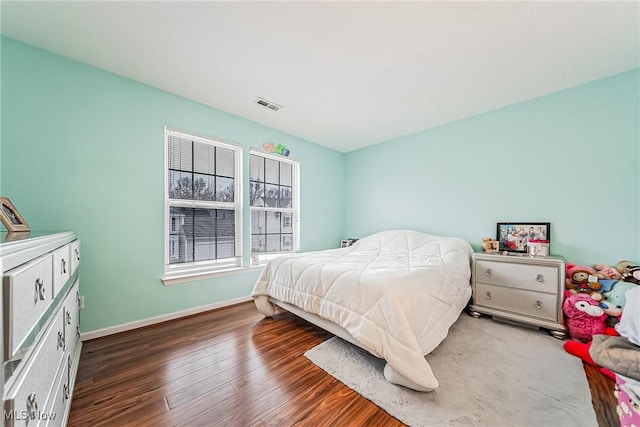 bedroom with dark hardwood / wood-style floors