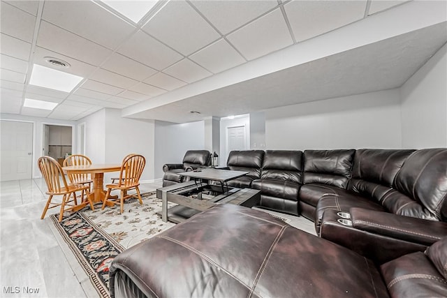 living room featuring hardwood / wood-style flooring and a drop ceiling