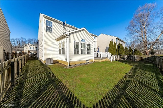 back of property with a yard and central air condition unit