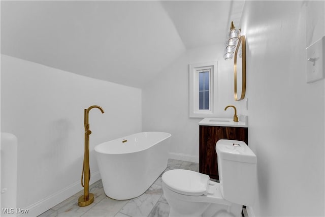 bathroom featuring vanity, a tub to relax in, lofted ceiling, and toilet