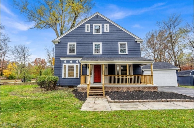 view of property with a garage, a front lawn, and a porch