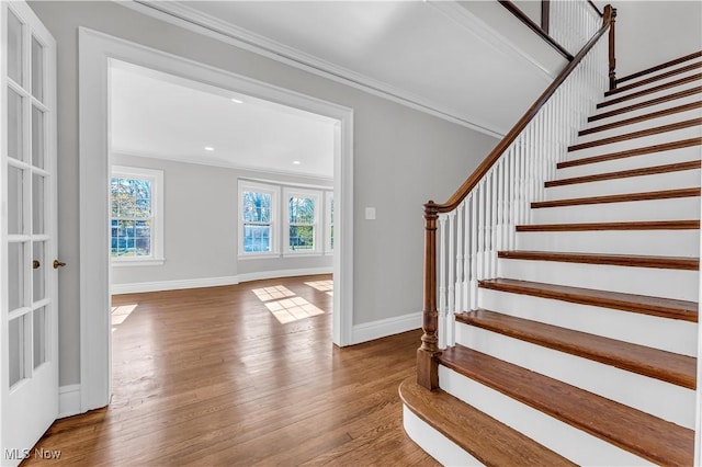 interior space with hardwood / wood-style floors and crown molding