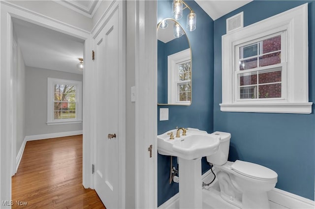 bathroom featuring wood-type flooring and toilet