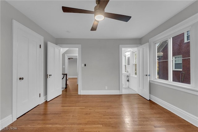 unfurnished room with light hardwood / wood-style flooring and ceiling fan