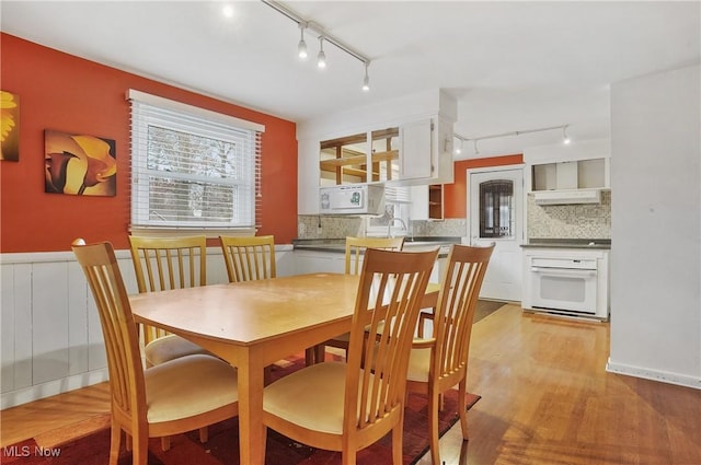 dining room featuring sink and light wood-type flooring