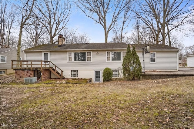 rear view of house featuring a yard, cooling unit, and a deck