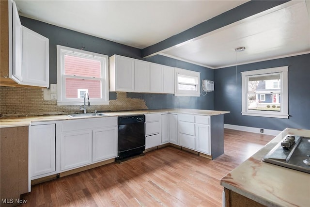 kitchen with white cabinetry, hanging light fixtures, black appliances, and sink