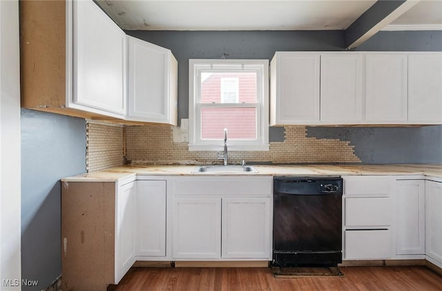 kitchen featuring white cabinetry, black dishwasher, sink, and light hardwood / wood-style flooring