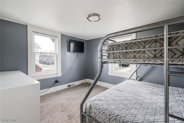 bedroom featuring ornamental molding and carpet flooring