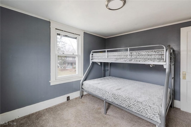 bedroom featuring crown molding and carpet flooring