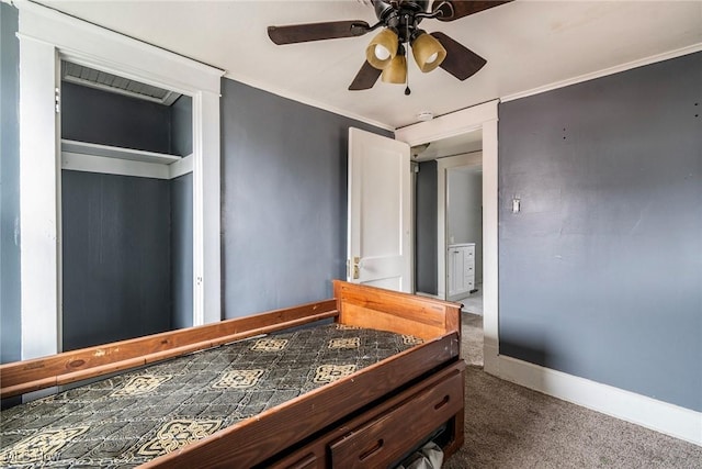 bedroom with crown molding, ceiling fan, and dark colored carpet