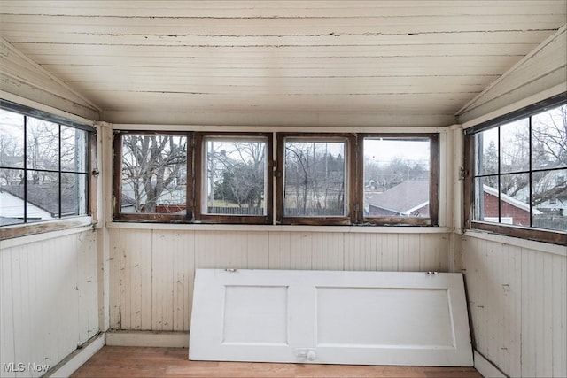 unfurnished sunroom featuring lofted ceiling and wood ceiling