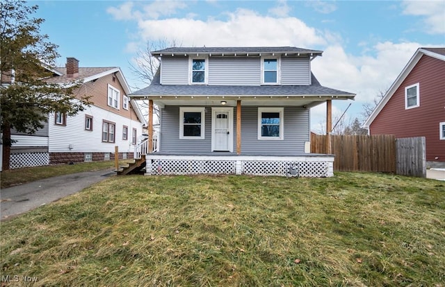 view of front of home with covered porch and a front lawn