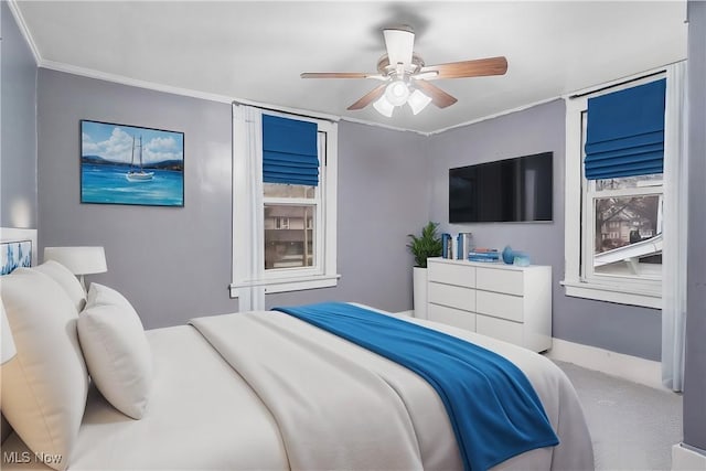 bedroom featuring crown molding, ceiling fan, and carpet